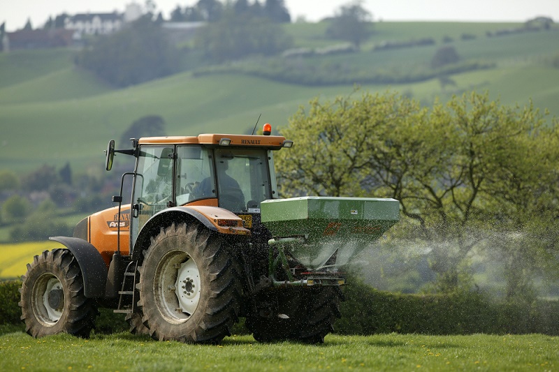 Tractor spreading fertiliser