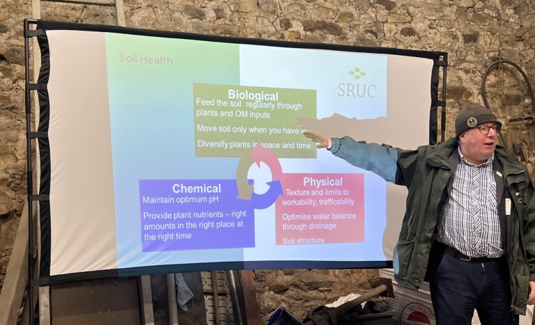 Speaker Paul Hargreave - in front of presentation screen