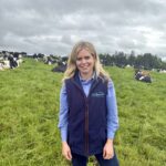 Sarah Harbison in a field with cows