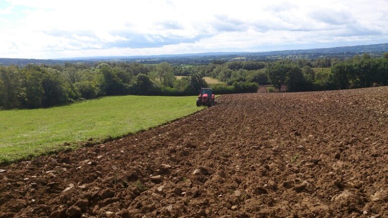 Image of field being ploughed by a tractor
