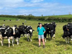 Caryn Webster stood outside with Holstein autumn calving cows