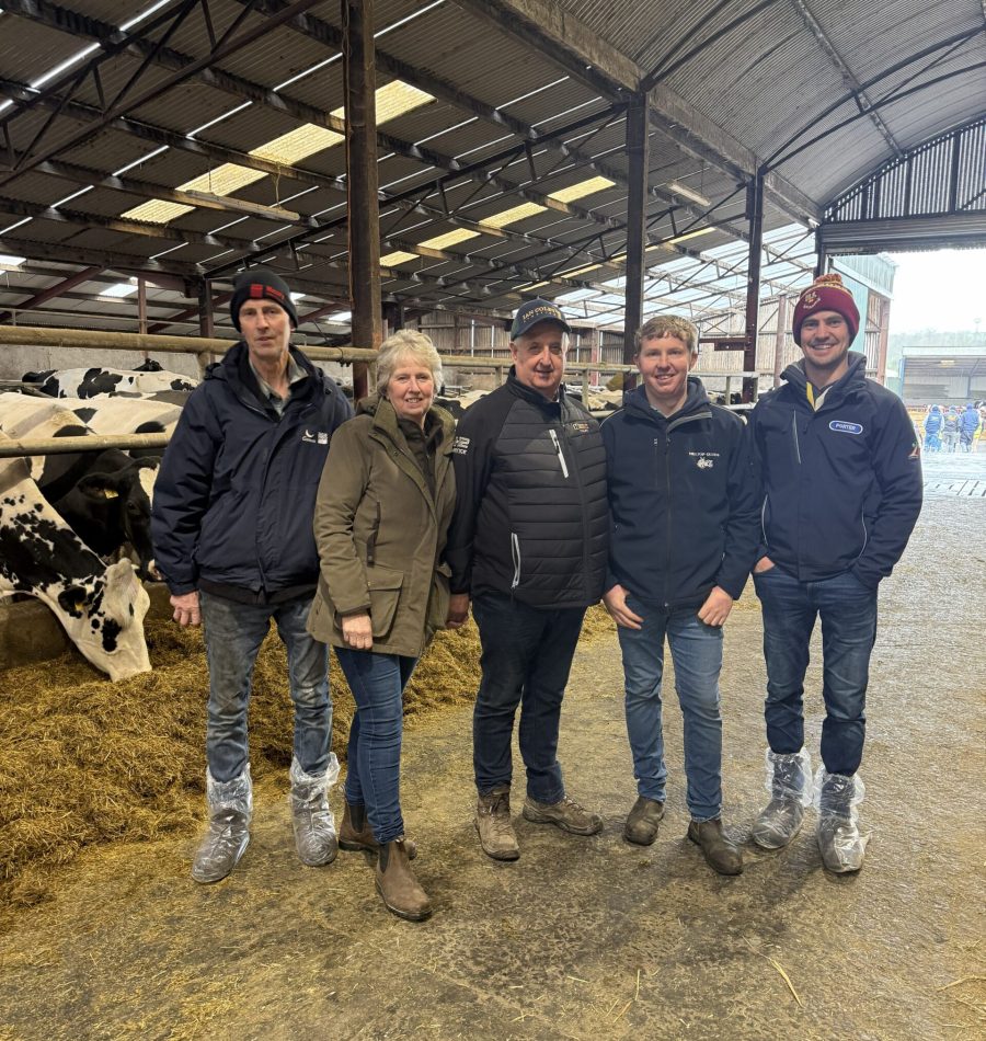 Five attendees stood in a cattle shed at the NI Open Meeting