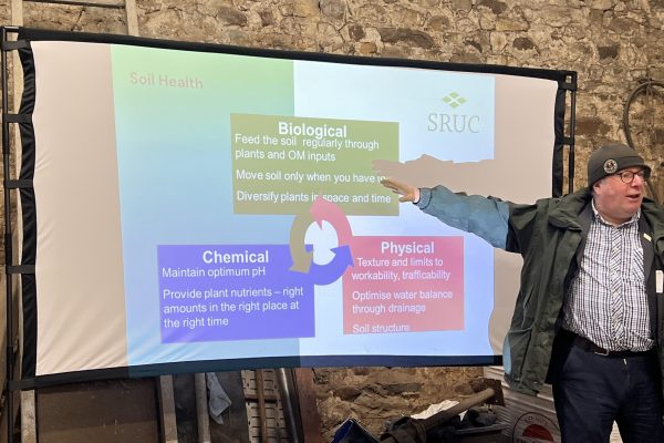 Speaker Paul Hargreave - in front of presentation screen