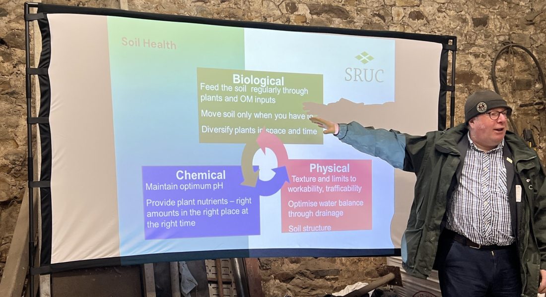 Speaker Paul Hargreave - in front of presentation screen